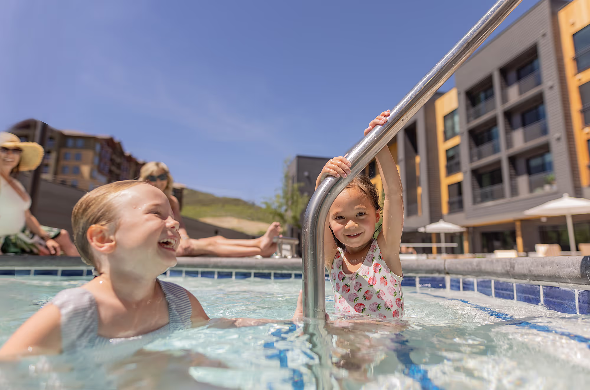 Children playing and laughing in the pool.