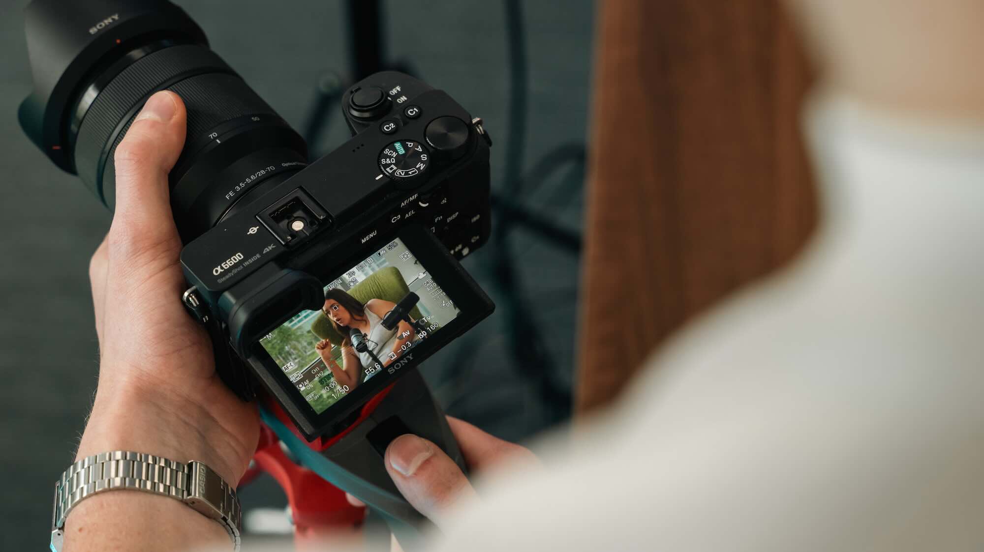 A woman chatting whilst being filmed on camera.