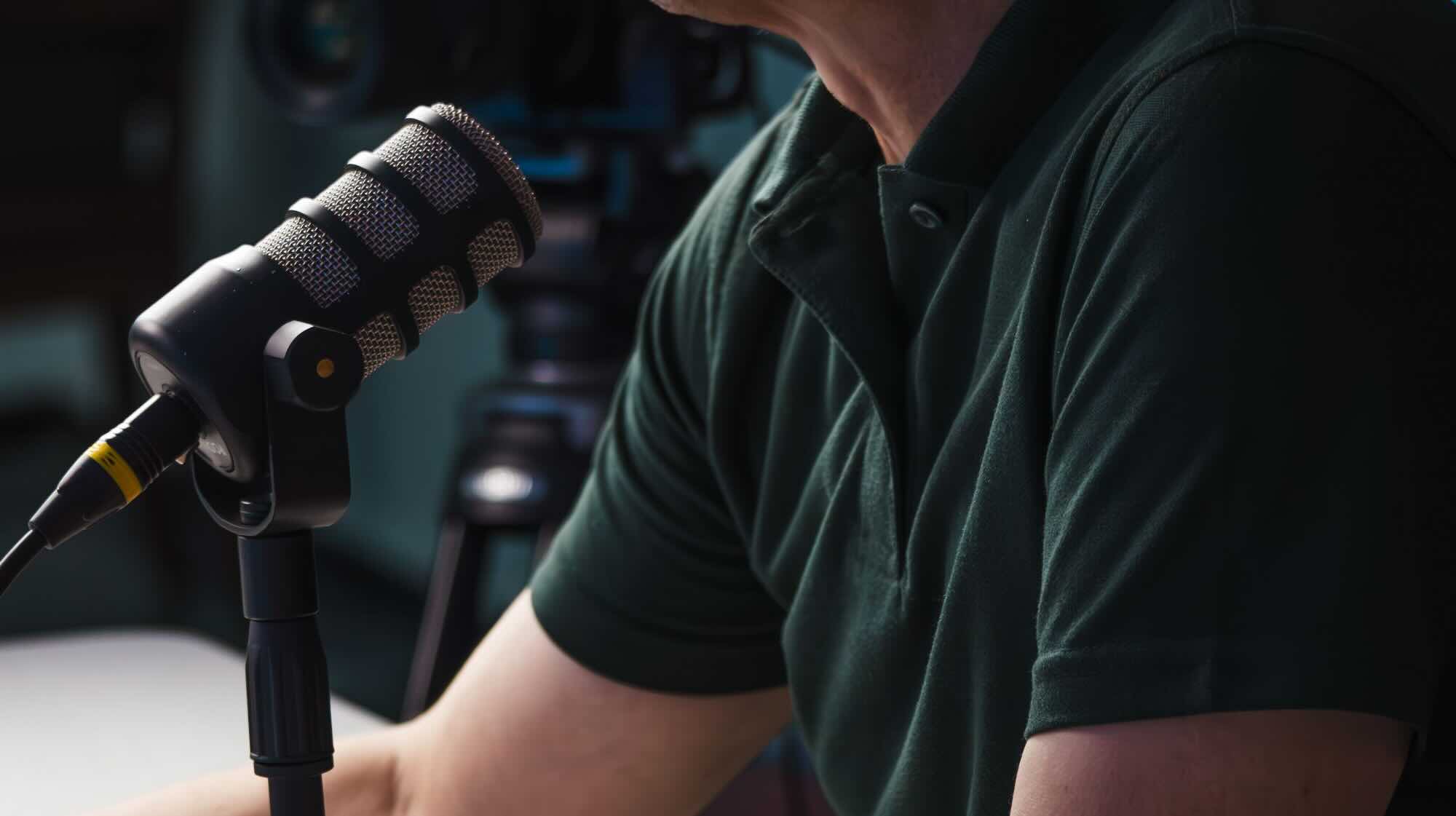 Man chatting into microphone alone.