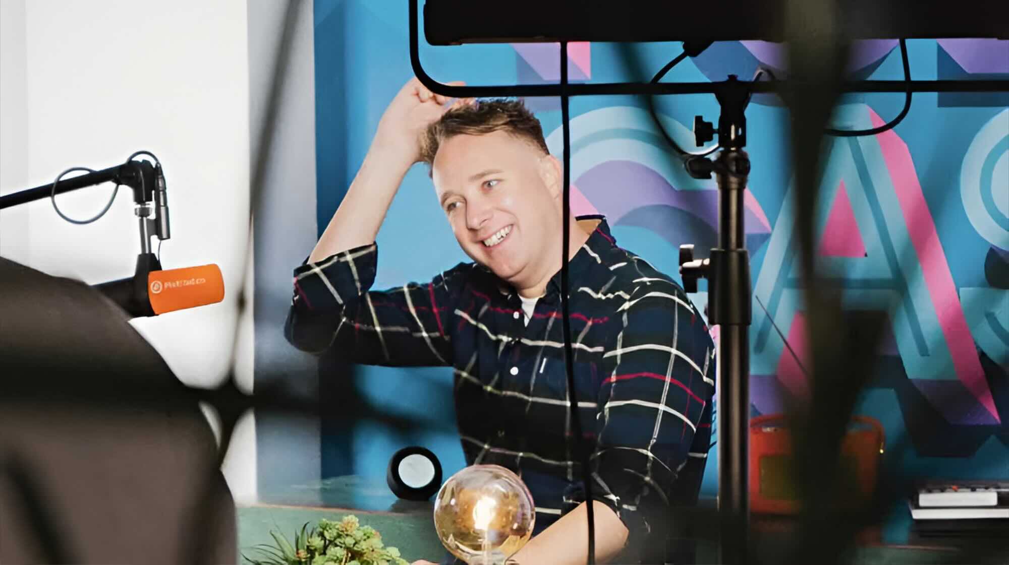 James Mulvany, CEO of Cue, laughing behind the scenes at a video shoot.