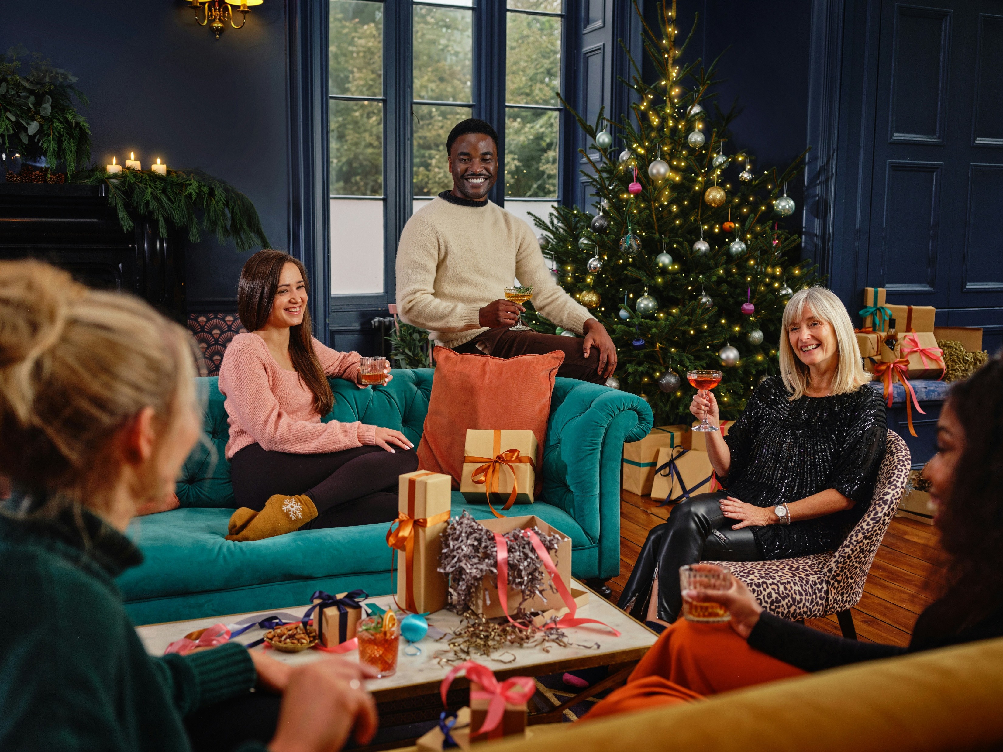 Family spending time together in living room at Christmas