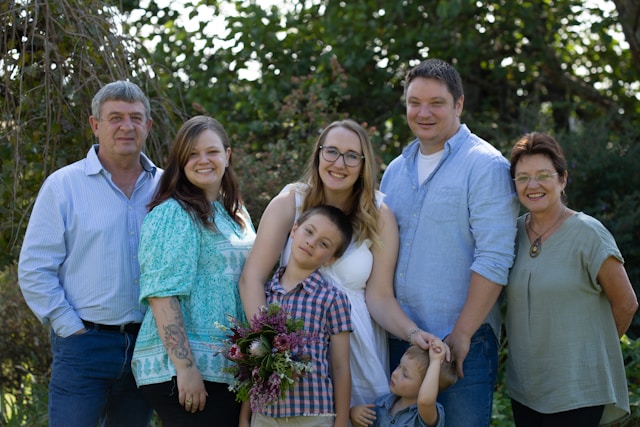 host family and exchange student posing outside for photo