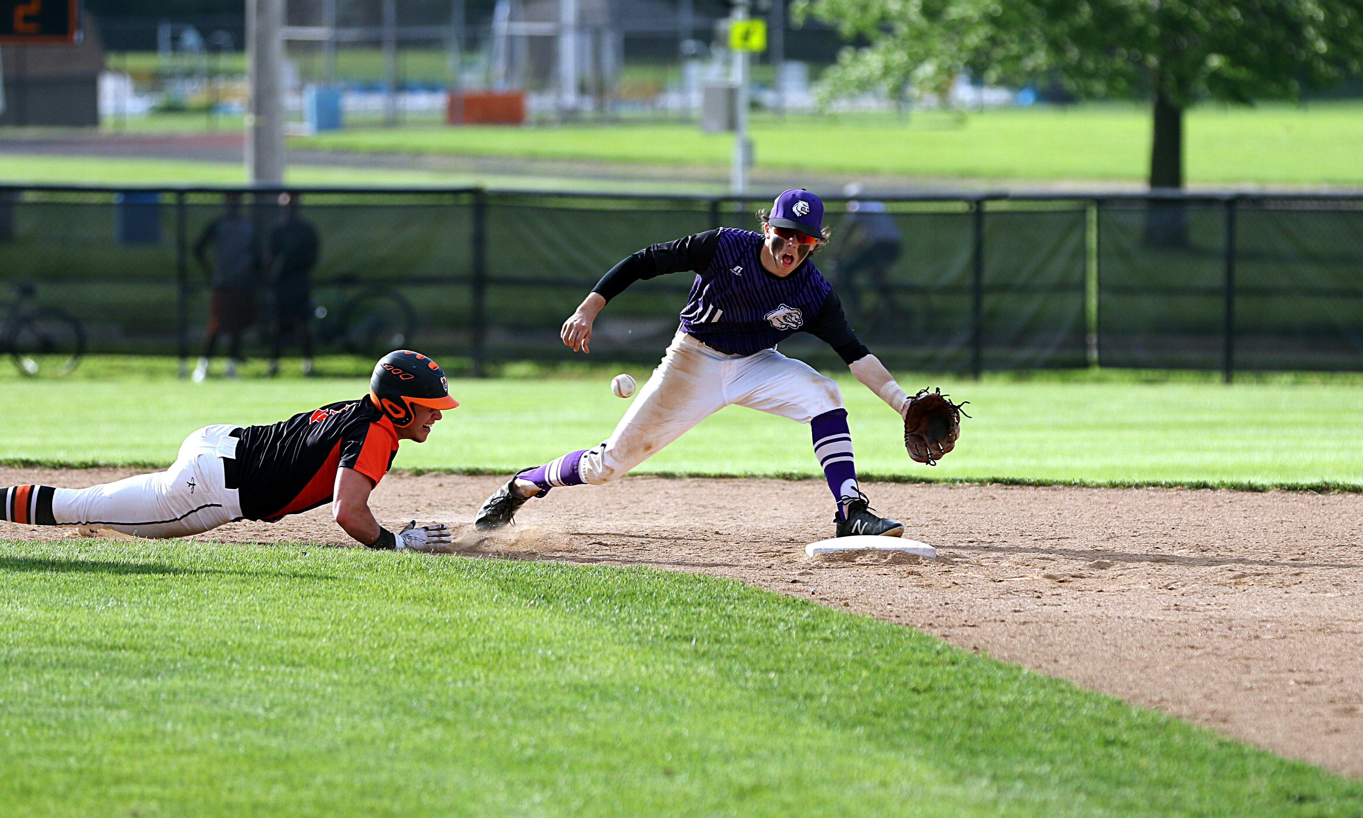 Two teens playing baseball