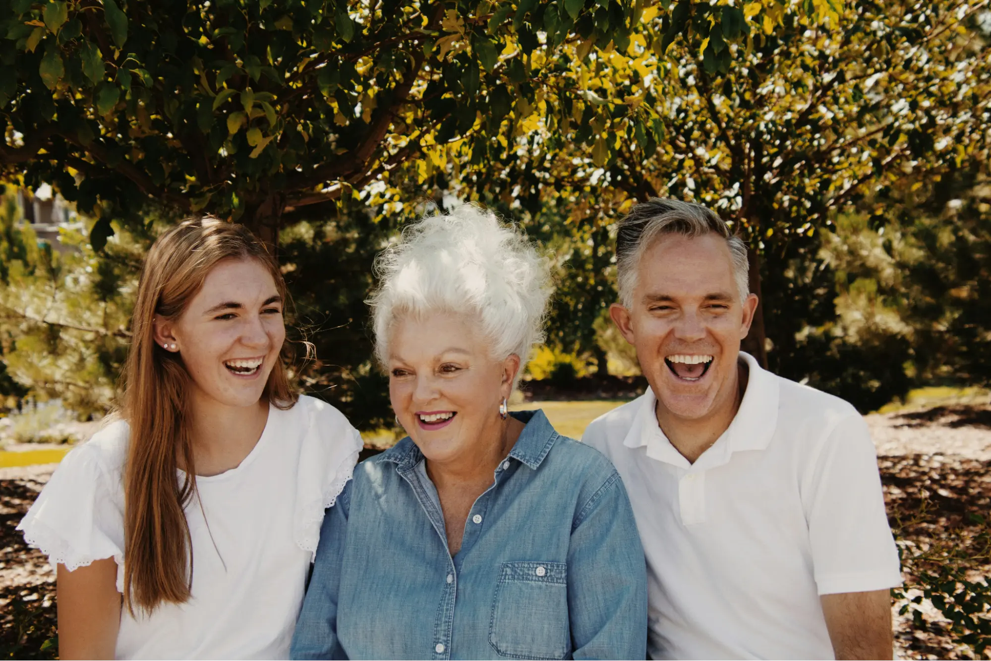 Host family laughing outdoors with their exchange student
