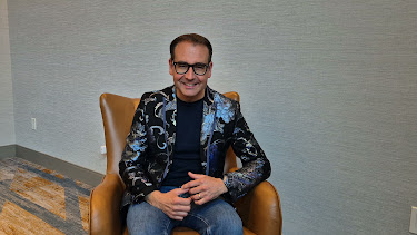 Oli Barrett seated during the AI persona filming session