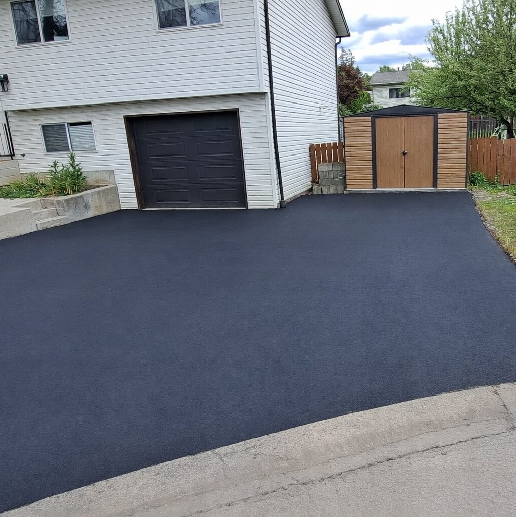 After, driveway repaired and widened across grass.