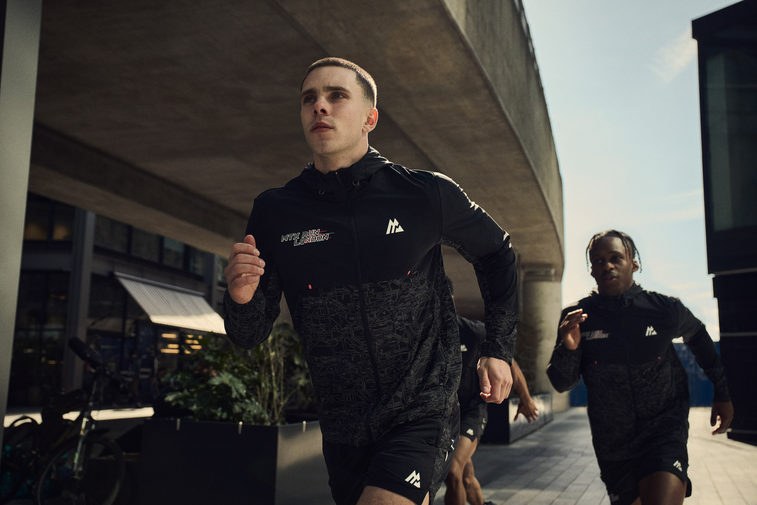 Runners in black Montirex sportswear during an urban active lifestyle campaign.