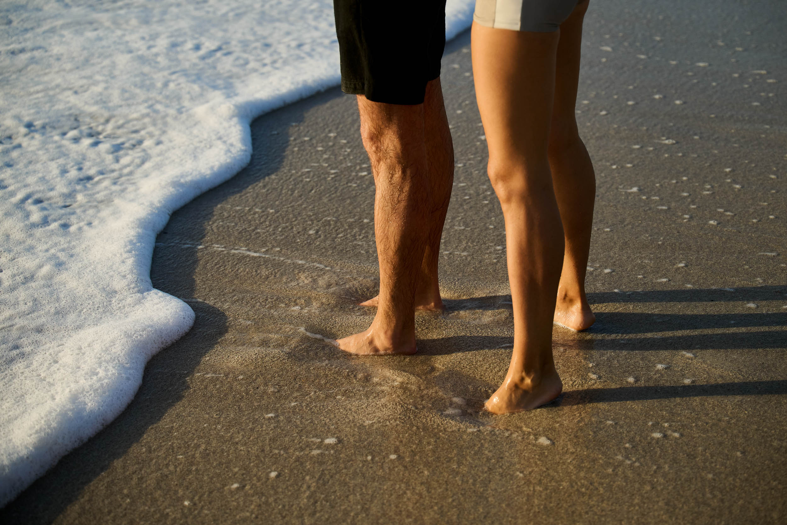 Bare feet standing in soft surf on an a caribbean beach