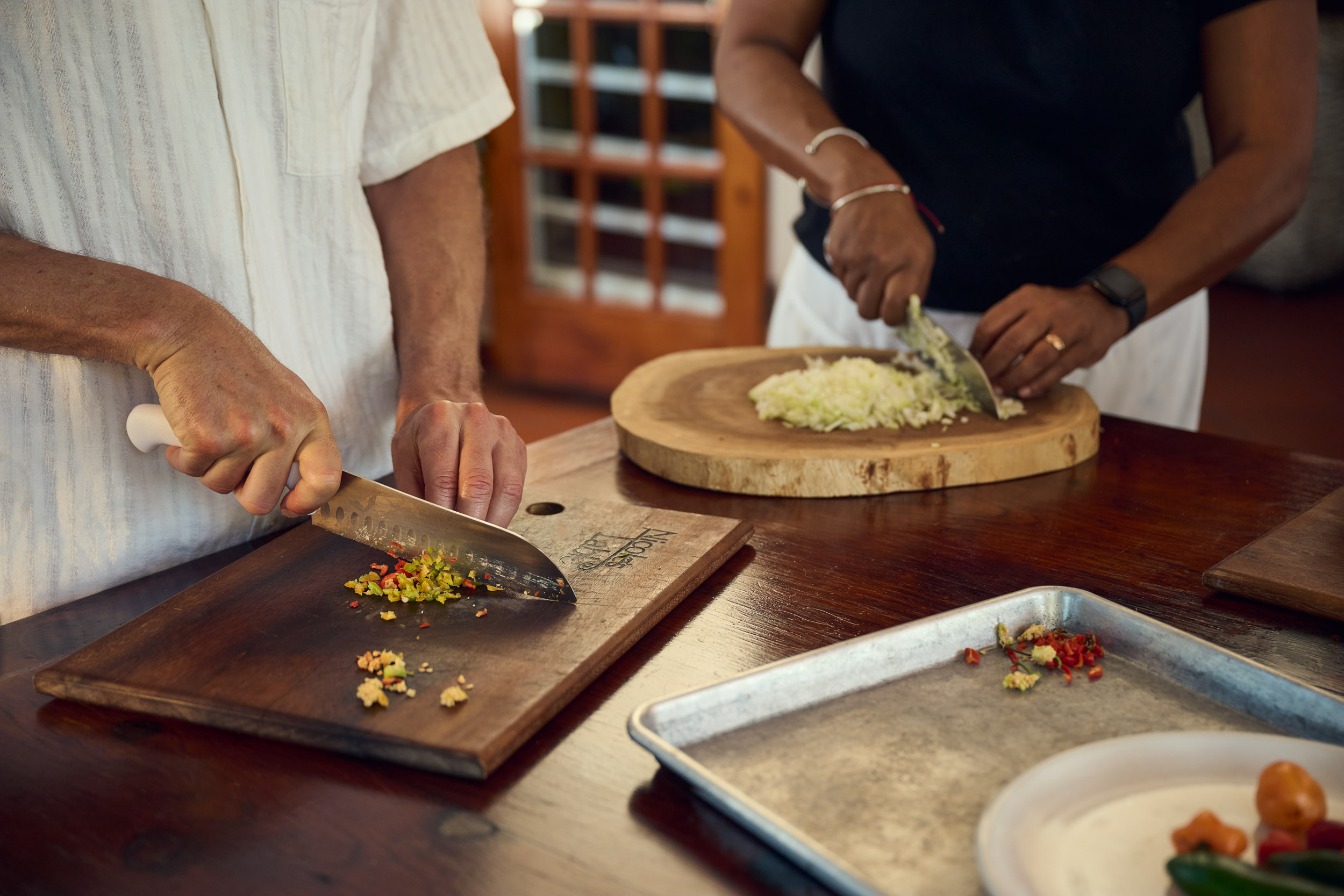 Hands preparing fresh ingredients on wooden boards