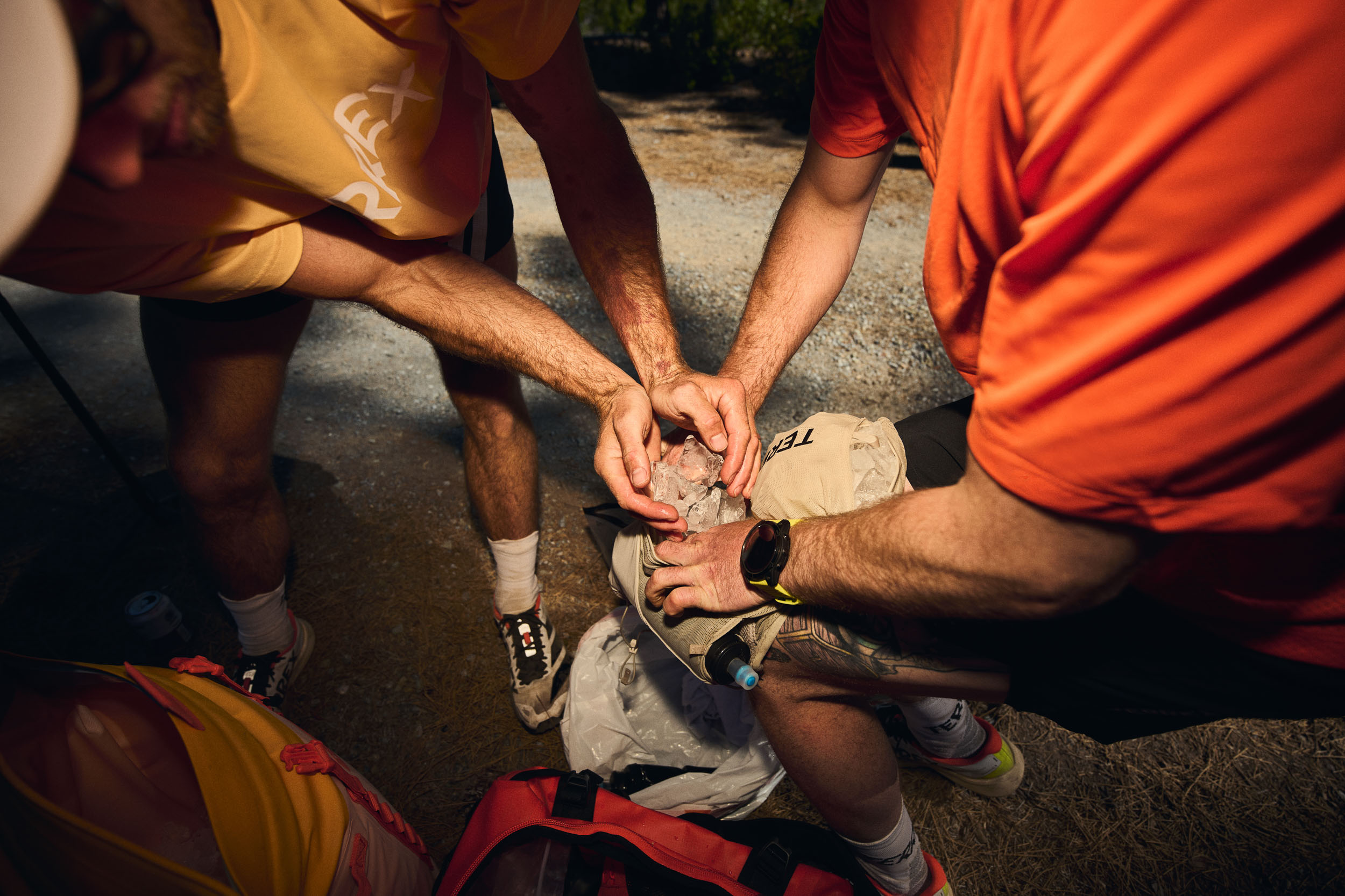 Three crew members pack ice into a hydration vest before Fiona arrives.