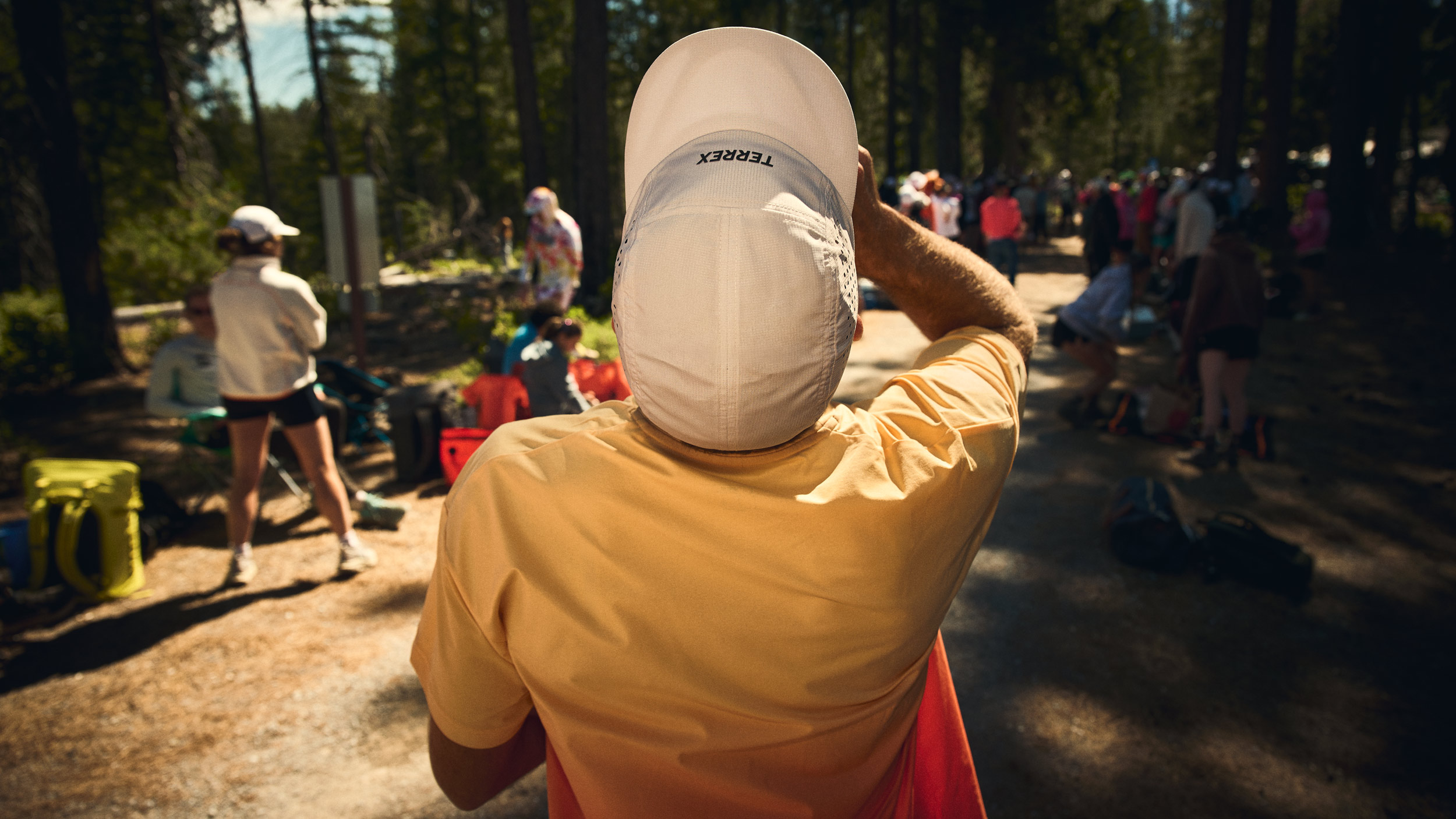 Rear view of a crew member waiting among spectators for Fiona Pascall to arrive.
