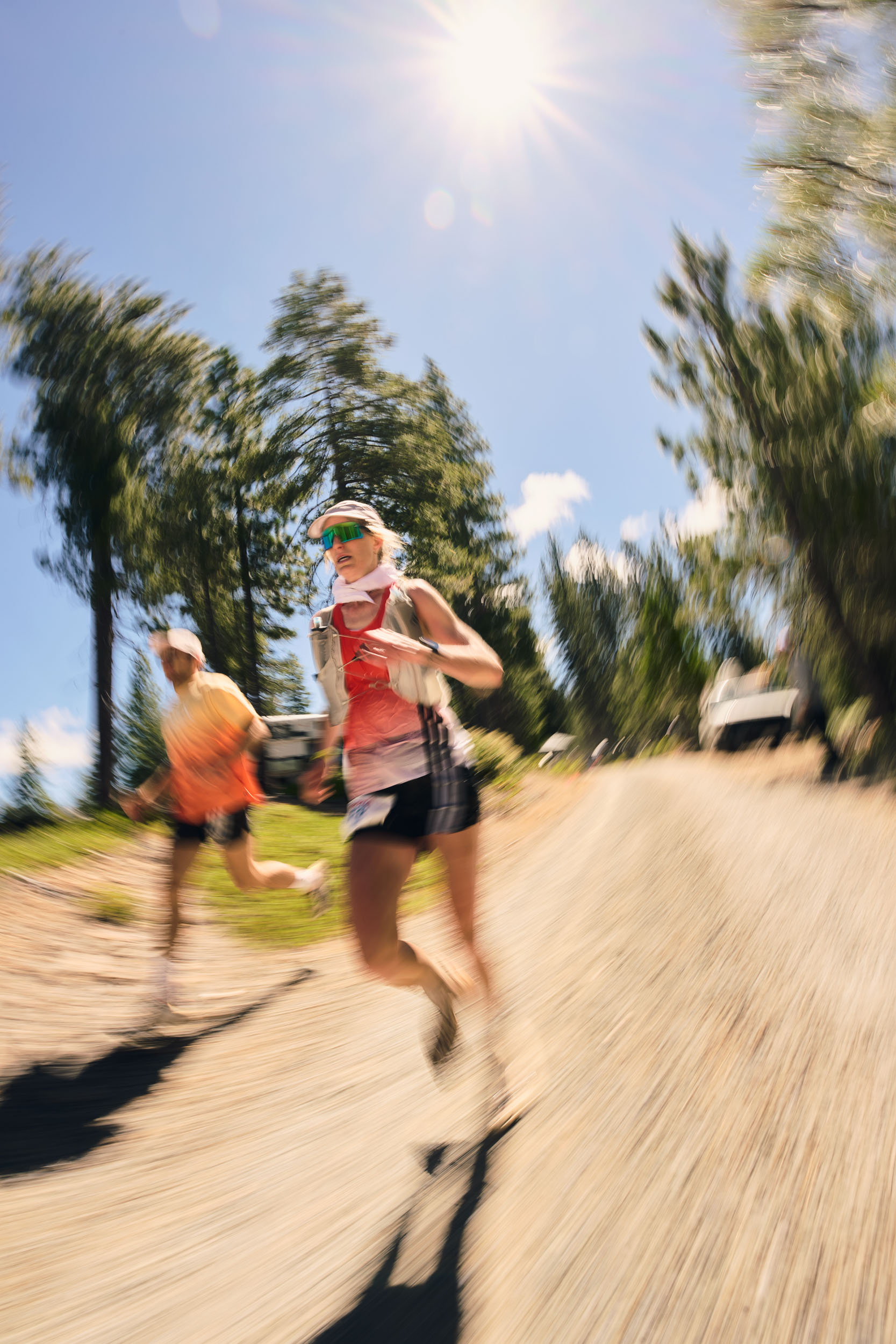 Motion-blurred Fiona Pascall and her pacer run beneath the bright California sun.