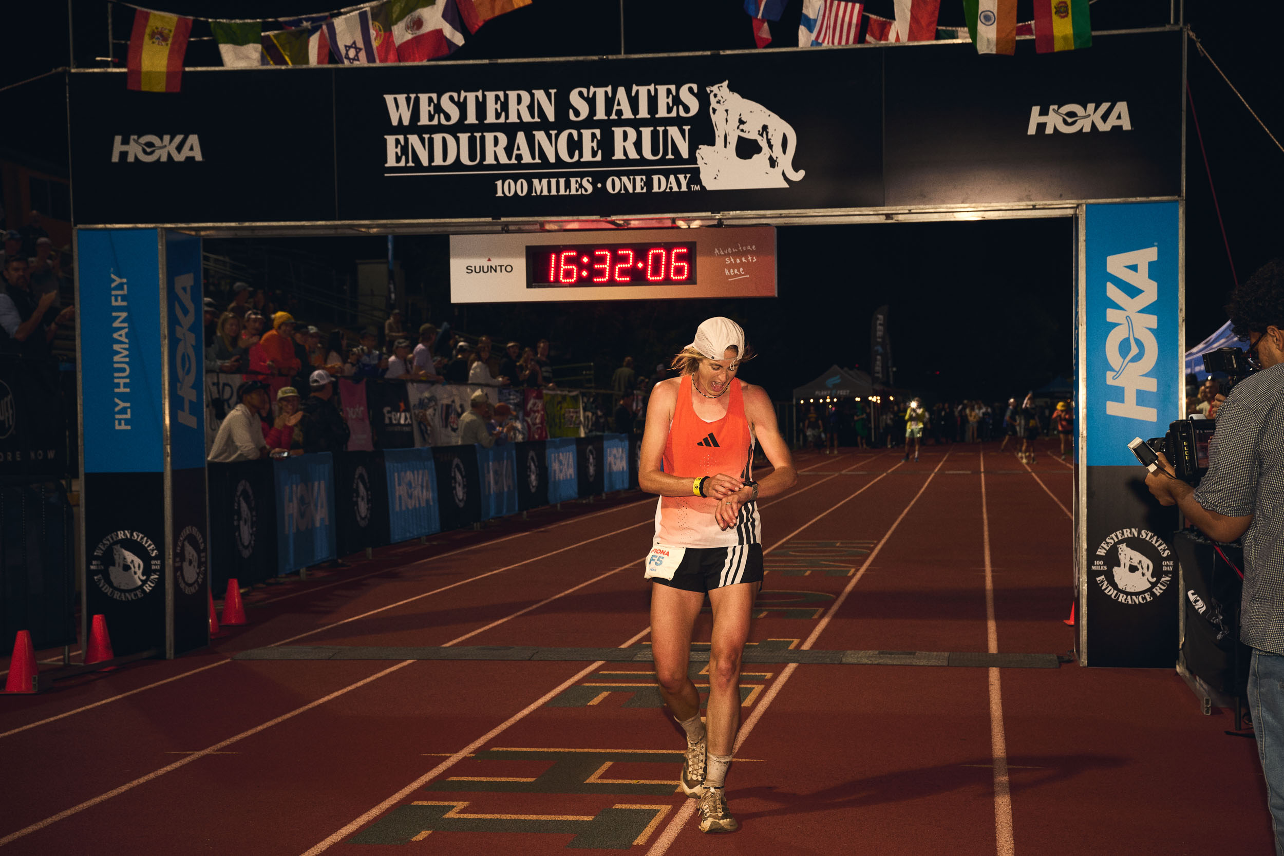 Fiona Pascall checks her watch beneath the Western States finish arch in Auburn.
