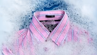 Channel in an ad break - a detergent commercial showing a pink striped shirt in soap suds