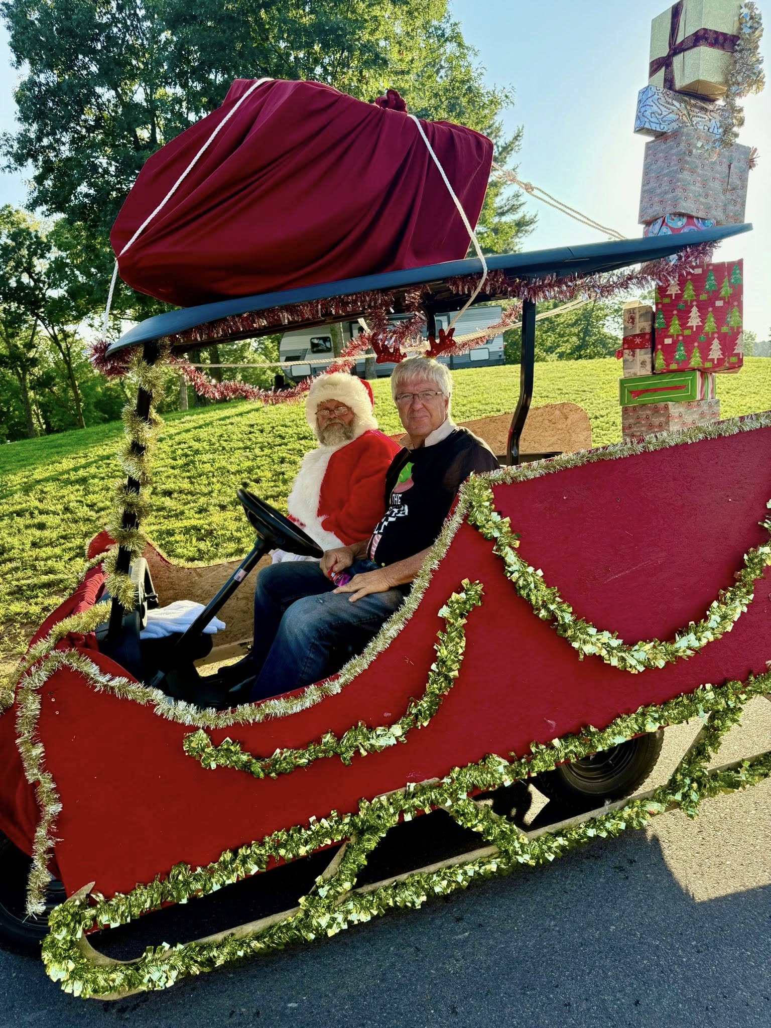 Santa Claus riding in the golf cart