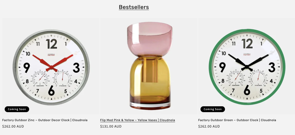 Bestsellers section showing three products - two outdoor clocks with "Coming Soon" labels priced at $262.00 AUD each, and a pink and yellow vase priced at $131.00 AUD