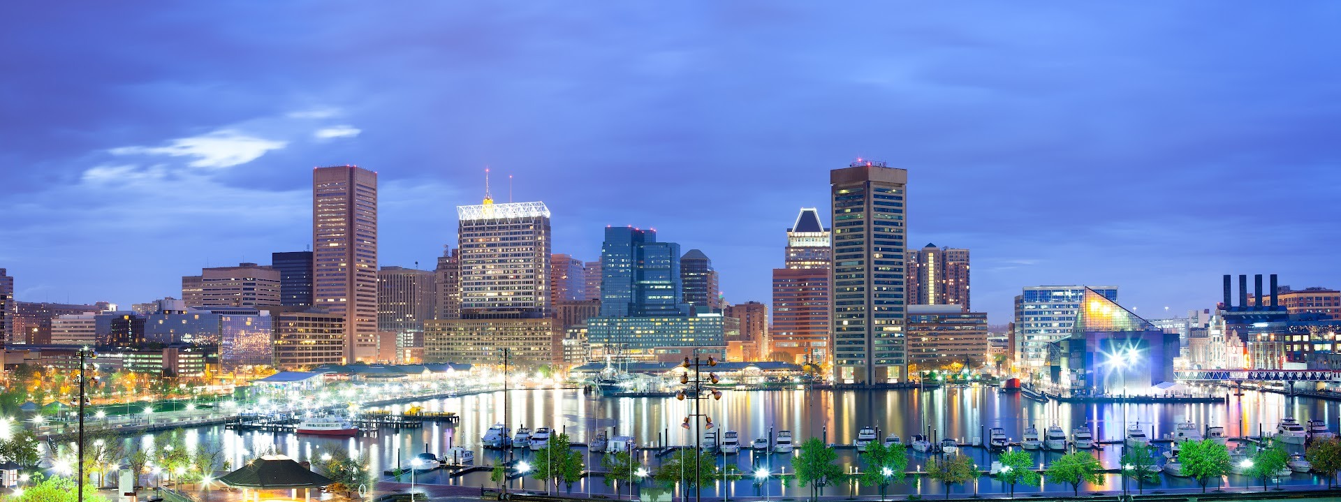 Downtown Baltimore skyline and Inner Harbor waterfront at dusk