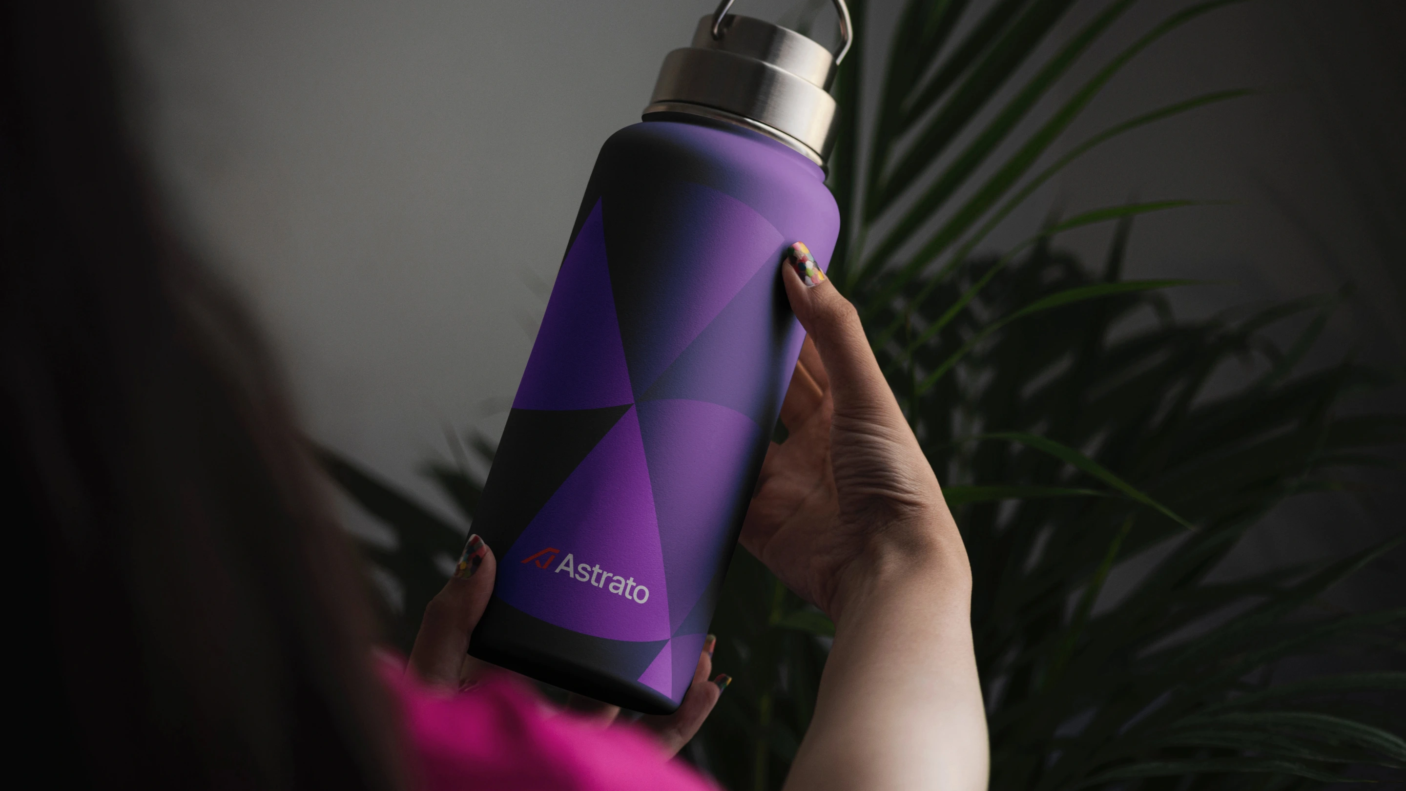 Astrato water bottle in persons hand