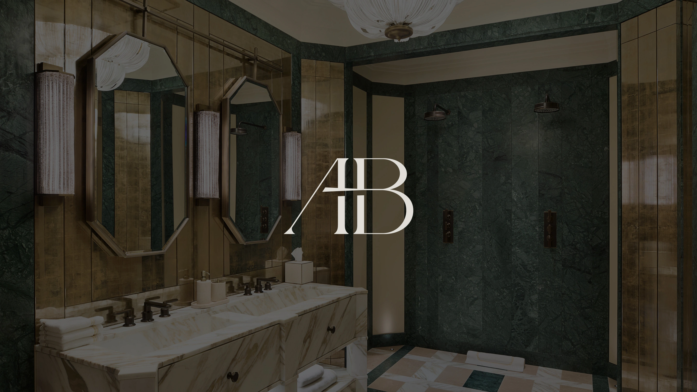 AB Monogram design on top of an image of a luxury bathroom featuring double mirrors and sink and a double marble shower
