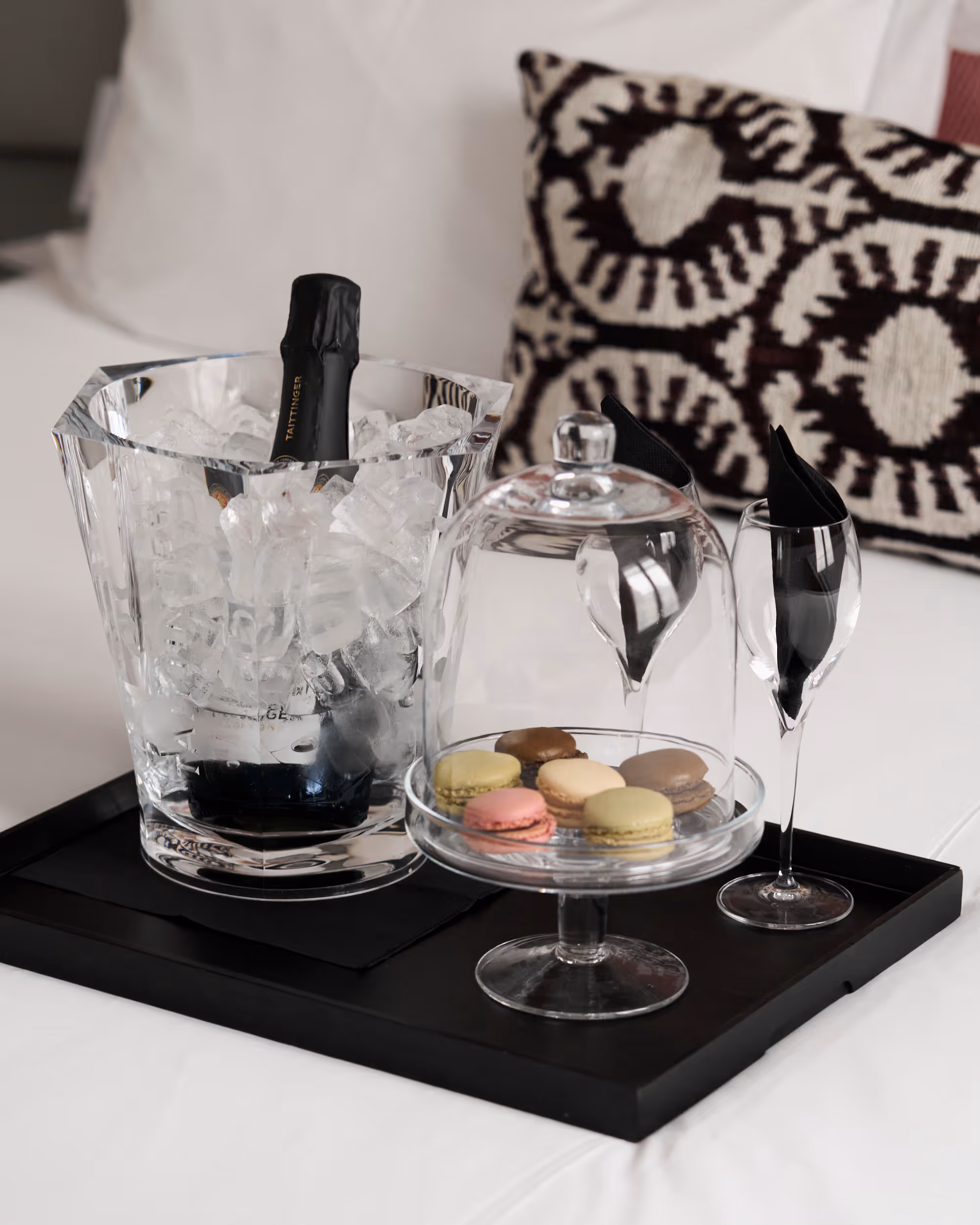 Champagne bucket with a bottle and glasses on a tray in a hotel room