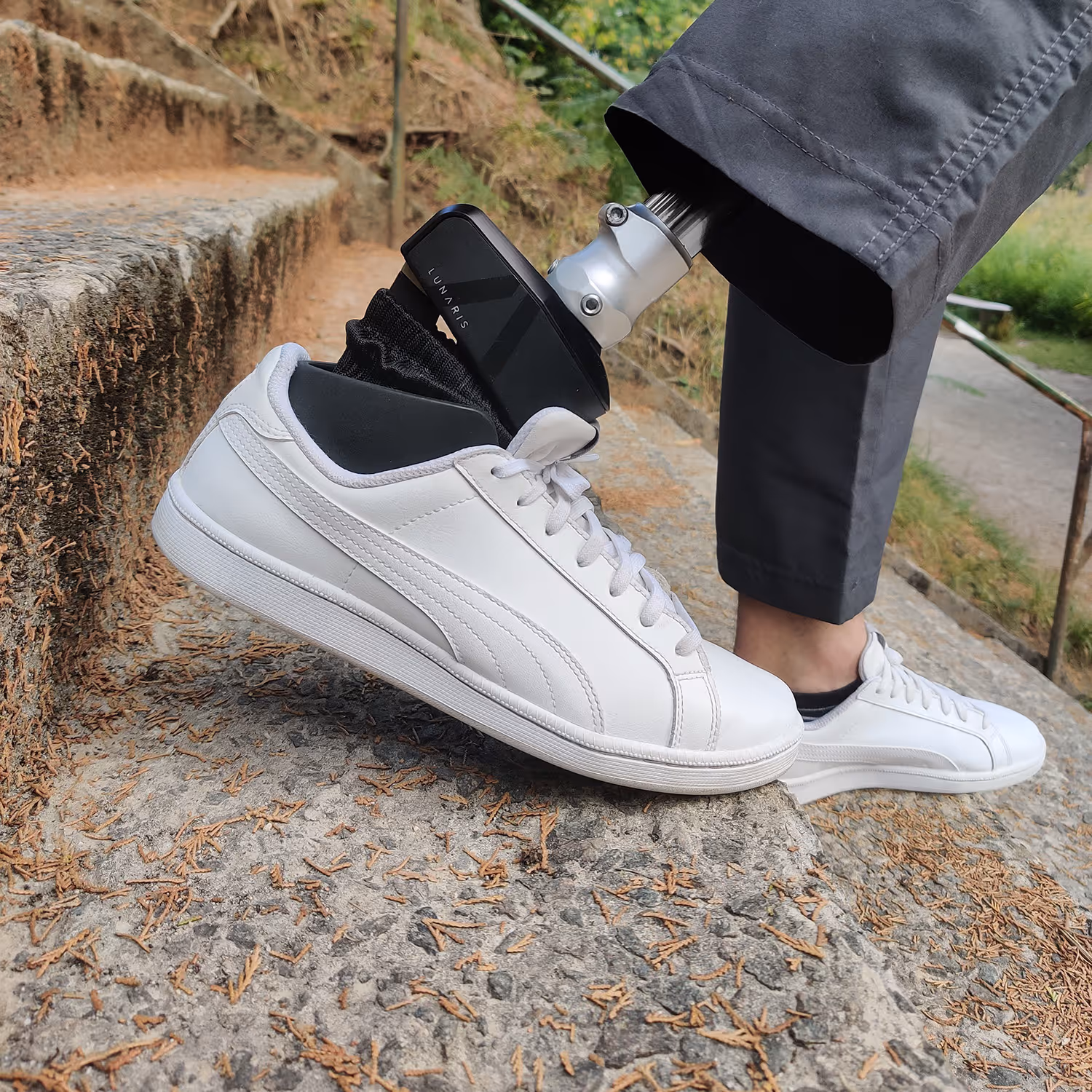 Close-up of sneaker with prosthetic leg on stairs