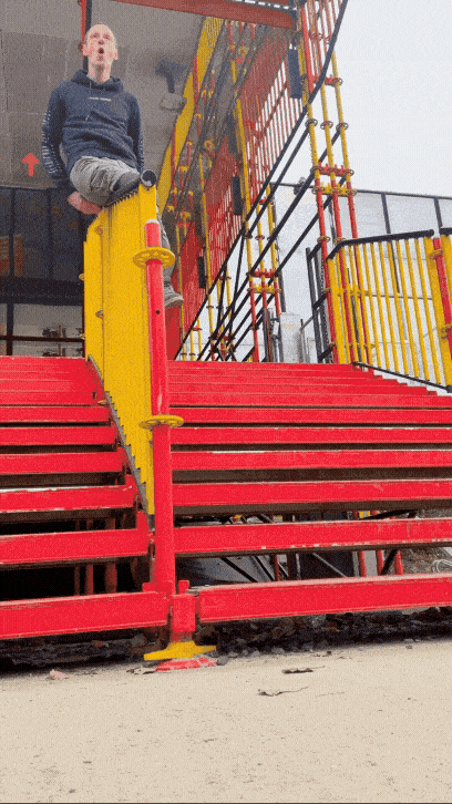 An amputee man having fun with a Lunaris prosthesis that slides down a ramp, causing a jolt in his prosthesis