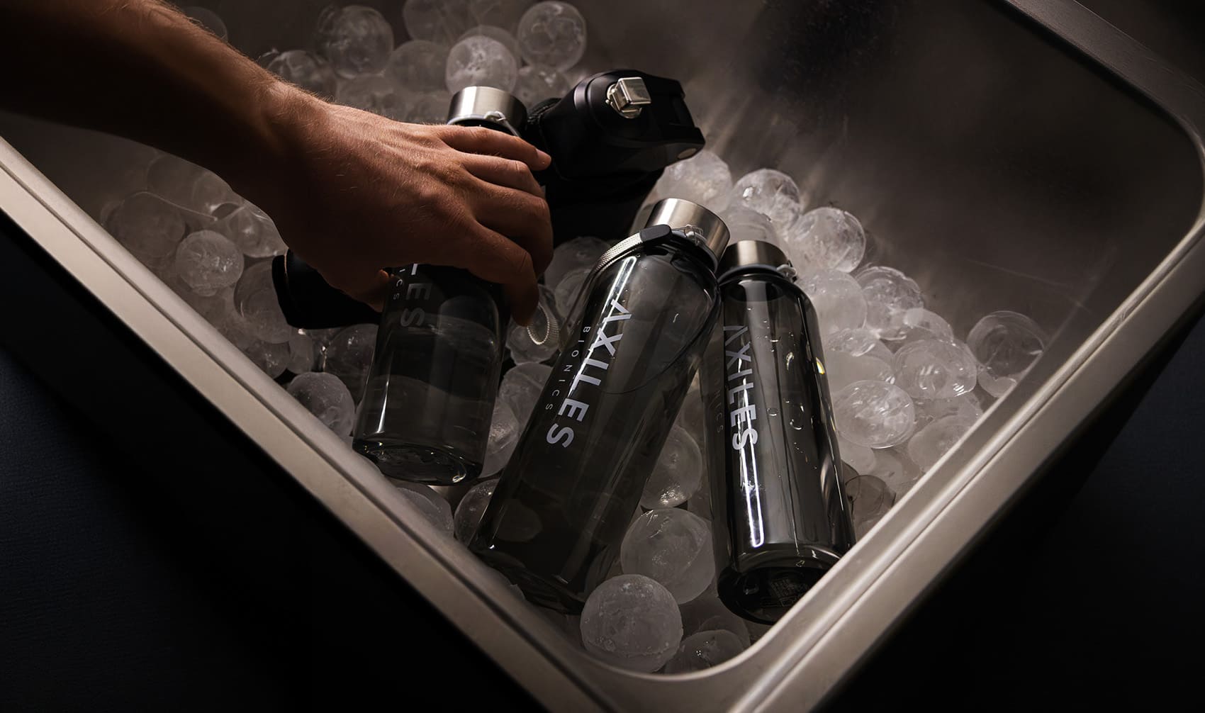 Axiles Bionics water bottles and Lunaris prosthetic foot in an ice-filled cooler