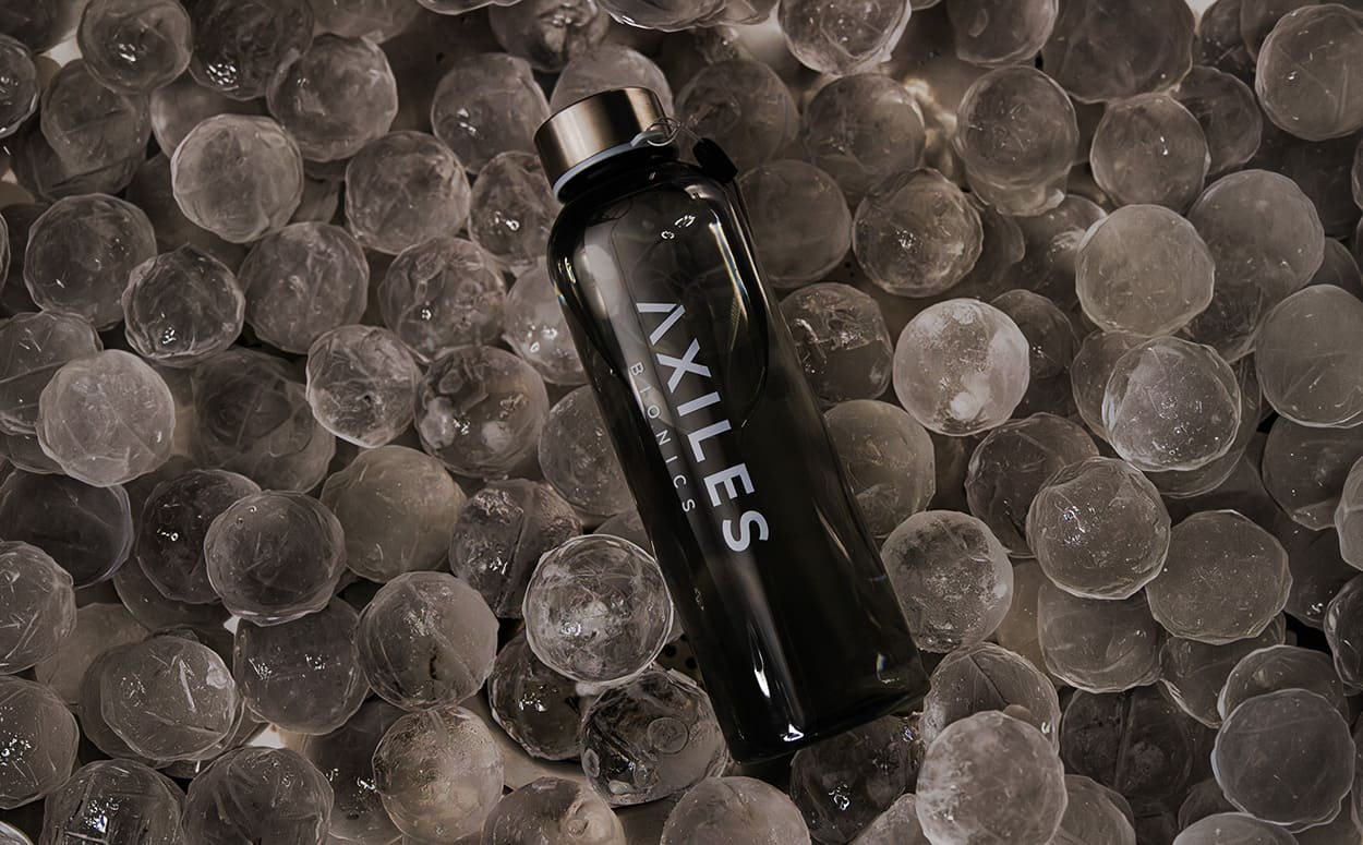 Axiles Bionics water bottles being picked up from a cooler filled with ice