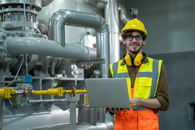 Engineer use laptop computer checking and inspection of HVAC heating ventilation air conditioning system on pressure gauge of industrial air compressor boiler pump room system. 