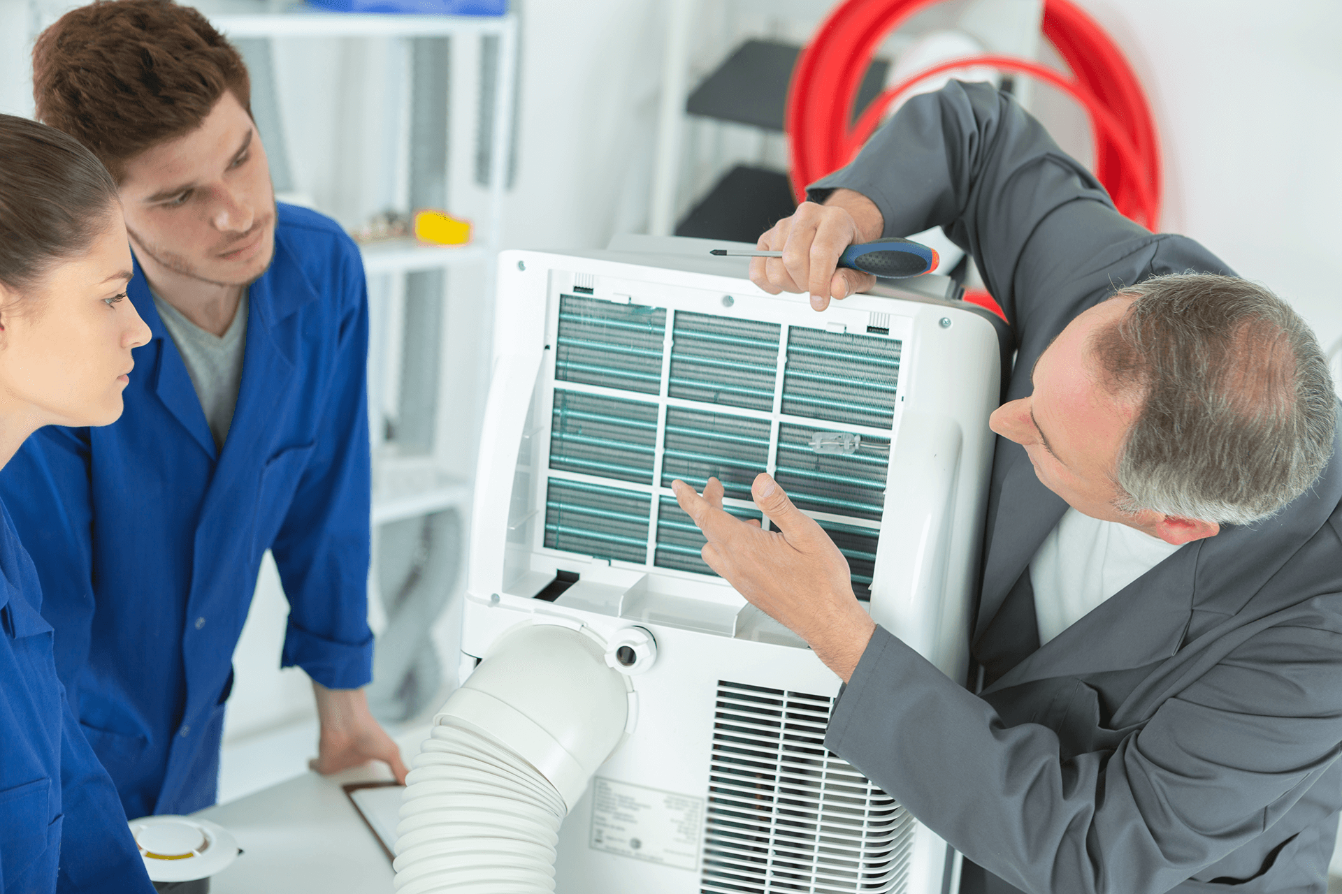 3 ac technicians repairing an industrial air conditioning compressor