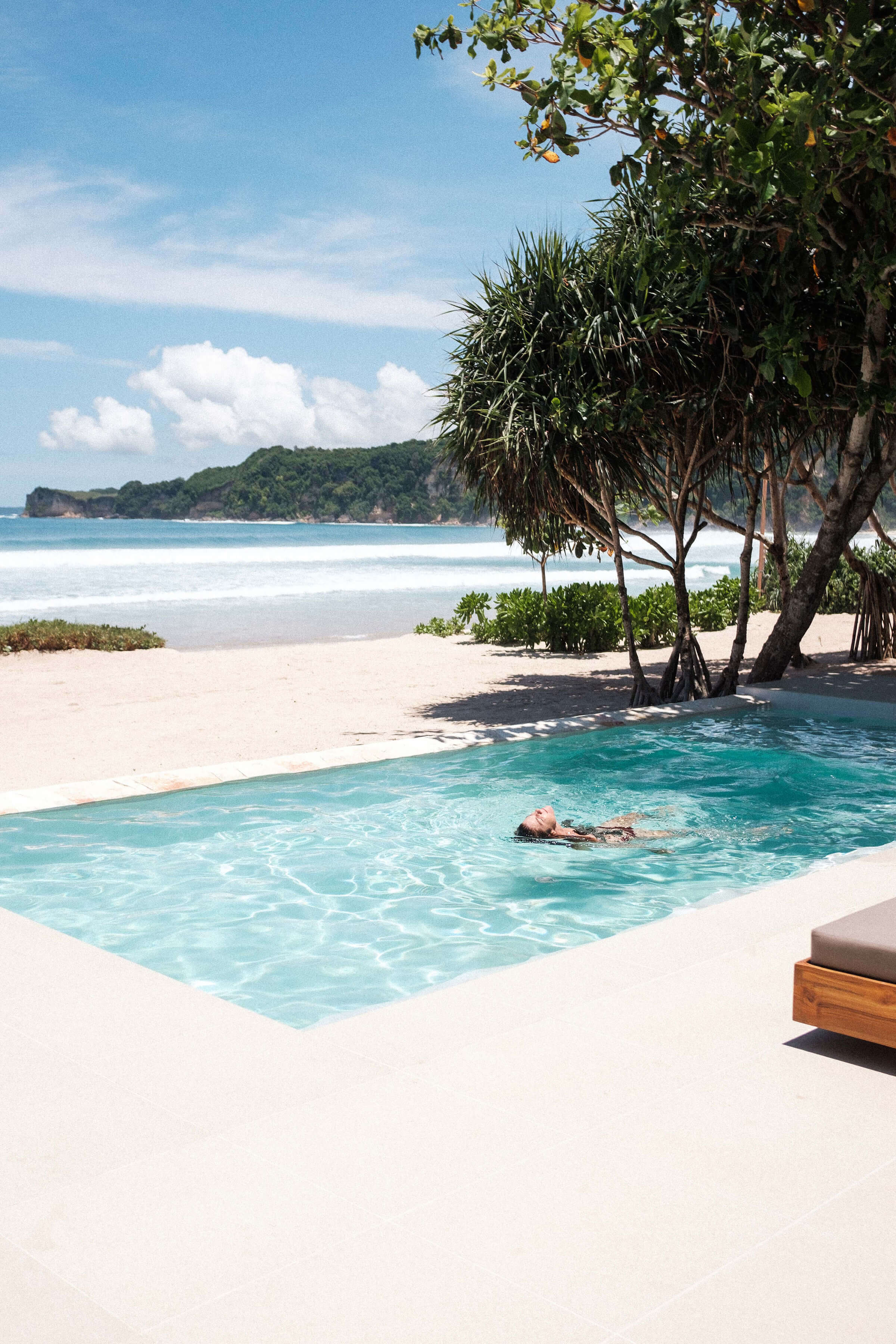 Beachfront Studio Pool Villa at The Sanubari, featuring a serene private pool and direct access to a white sand beach in Indonesia.