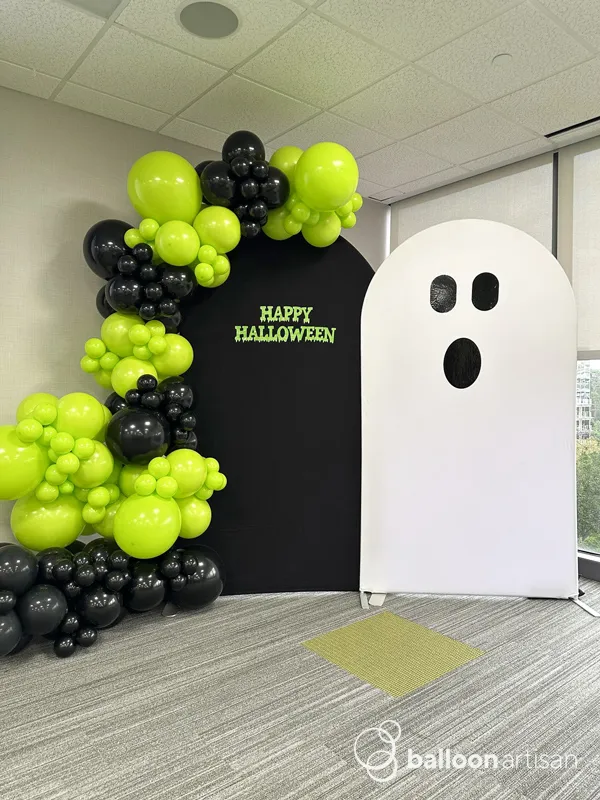 A ghost themed halloween balloon chiara arch install for a company halloween party.