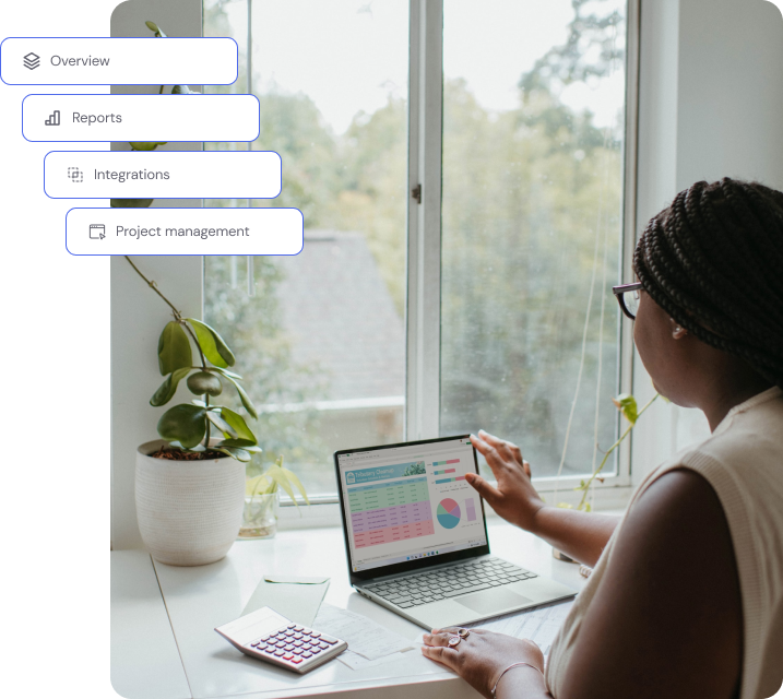 a woman sitting at a table with a laptop
