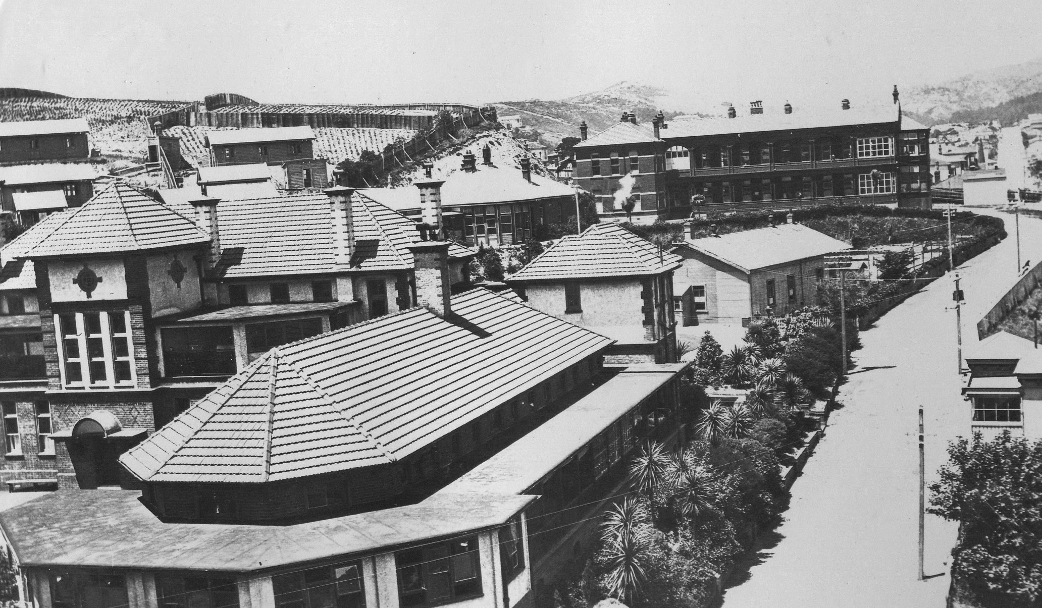 The road separating the Children's Hospital from the main hospital. Just behind the children's hospital is the "Tin Shed" and the Victoria Hospital is in the background. Wellington Hospital Archives, as gathered by Ron Easthope, honorary archivist.