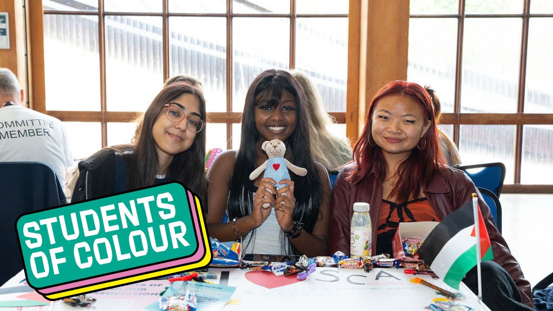 Three students of colour in a university study space
