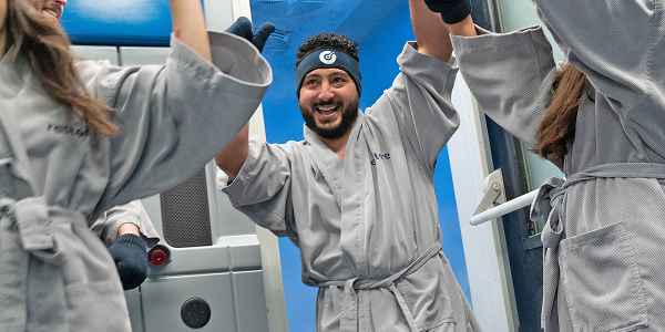 Man and woman exist Cryotherapy chamber at Restore Hyper Wellness