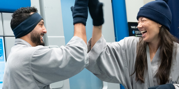 Man and woman high five after Cryotherapy at Restore Hyper Wellness