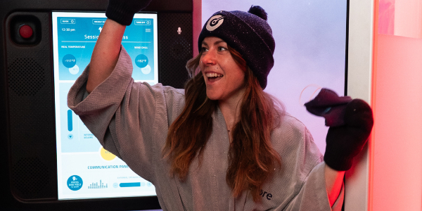Woman cheers as she exits Cryotherapy at Restore Hyper Wellness to help boost metabolism and weight loss.