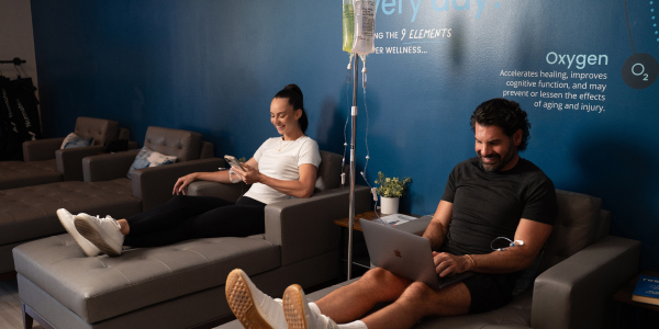 Woman and man get IV Therapy for recovery at Restore Hyper Wellness