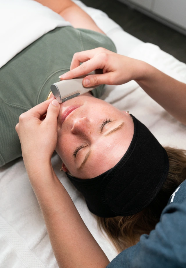 Woman receiving DERMAFLASH LUXE+ Sonic Dermaplaning