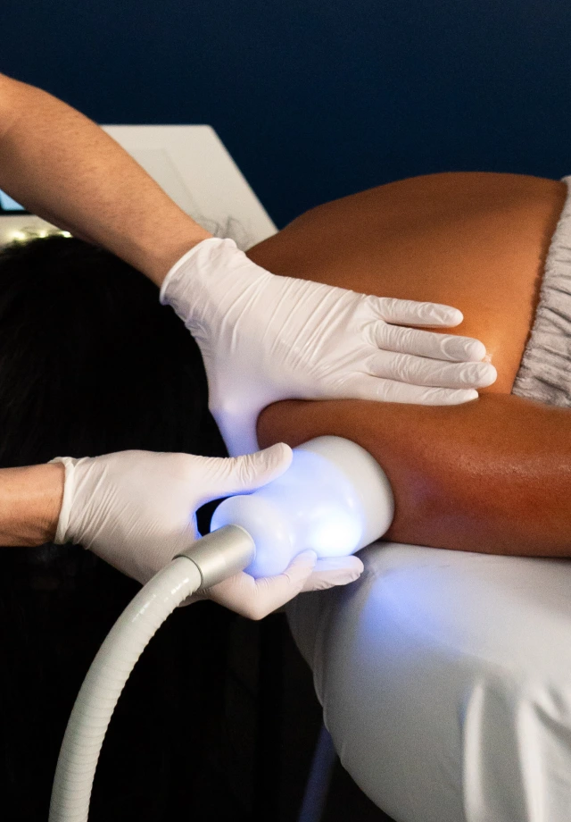 Woman with dark skin receiving Neveskin™ Tone on her arm