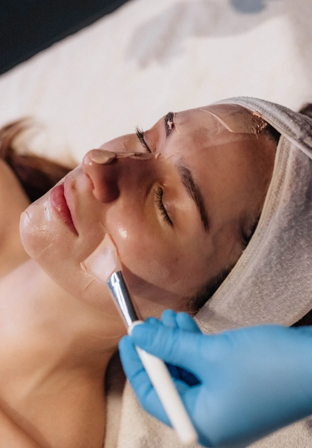 A Restore esthetician applying a Marini Retinol Plus facial 