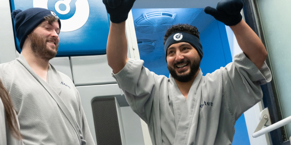 Woman enters Whole Body Cryotherapy chamber for pain management at Restore Hyper Wellness
