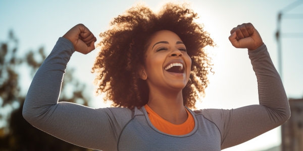 woman celebrating with hands raised in the air