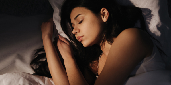 Woman wakes up after restful night sleep and IV Drip Therapy at Restore Hyper Wellness