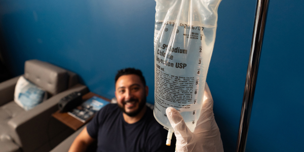 IV Drip is being administered to a happy client