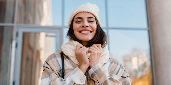 Woman in winter clothes smiles