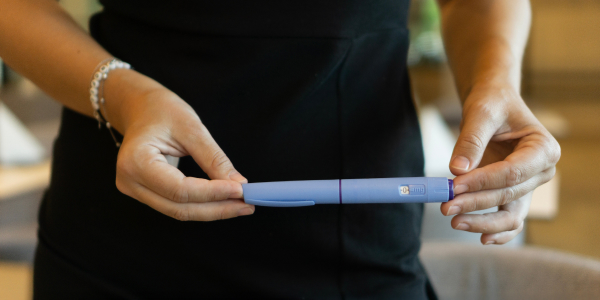 person holding GLP-1 pen