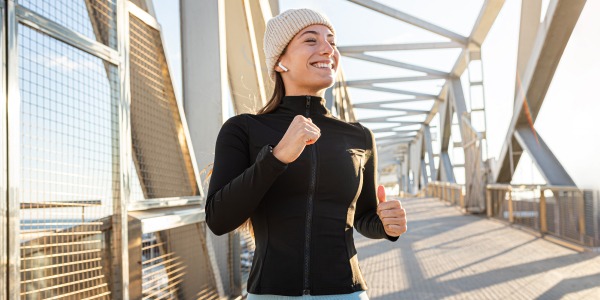 Image of happy woman running outside