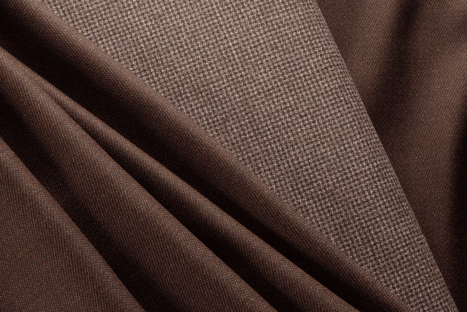Close-up of dark brown and light brown textured fabric folds.